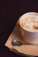 Morning coffee, Cappuccino coffee on wooden table. Beautiful foam, greenery ceramic cups, stylish toning, place for text.