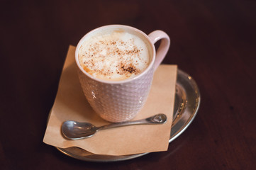 Morning coffee, Cappuccino coffee on wooden table. Beautiful foam, greenery ceramic cups, stylish toning, place for text.