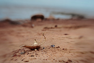 Magic lamp in the desert from the story of Aladdin with Genie concept for wishing, luck and magic....