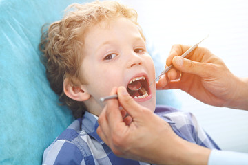 Close up of boy having his teeth examined by a dentist