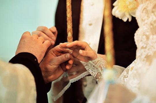 Wedding in Orthodox church. The wedding ceremony. Wedding rings. Religion. Cross oneself
