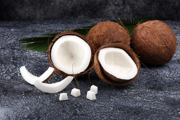 Ripe half cut coconut on a wooden background