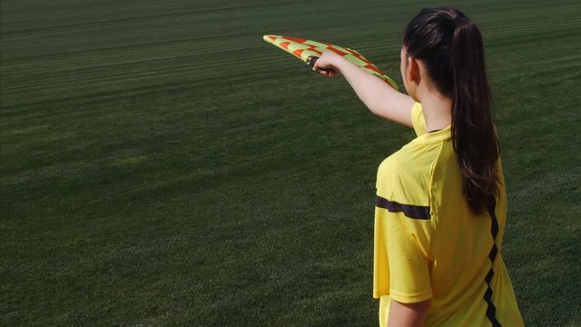 Assistant female referee moving along the sideline during a soccer match