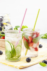 Herbs and fruits flavored infused water. Summer refreshing drink. Health care, fitness, healthy nutrition diet concept.