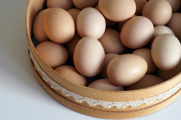 Eggs in weggs in a wooden tray on a white background  