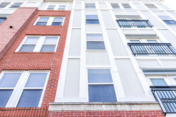 New construction exterior pattern of apartment condo, condominiums residential windows with brick...