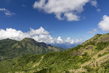 View from the Bena village of a dramatic valley and ocean beyond near Bajawa, Indonesia.