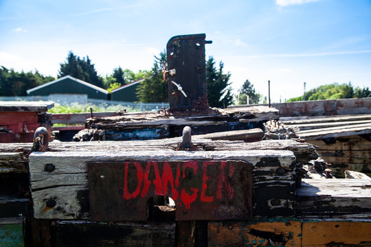 Danger sign on Rotting Wooden Structure of an old cargo  barge
