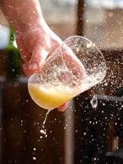 Man hand holding a glass of asturian, spanish apple cider