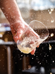 Man hand holding a glass of asturian, spanish apple cider
