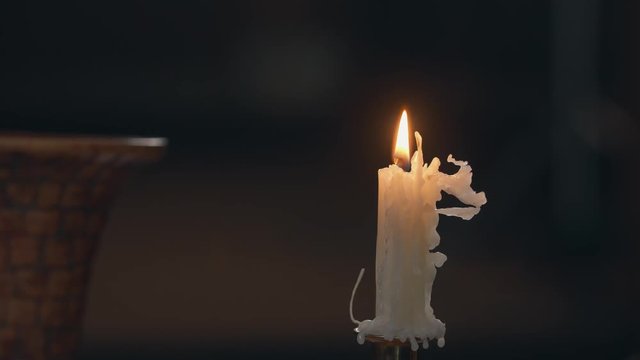 Close Up Of Candle Dripping Wax In An Old, Dark Church