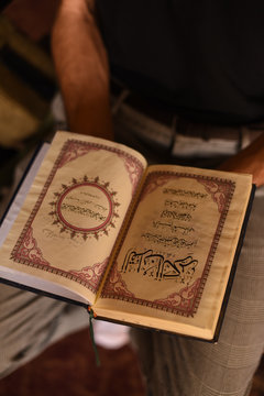Man holding the Quran
