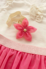 Concept of children's clothing, fashionable children's clothes, fashion. Skirt with flower headband, shoes for girl.