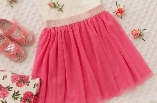 Concept of children's clothing, fashionable children's clothes, fashion. Skirt with flower headband, shoes for girl.