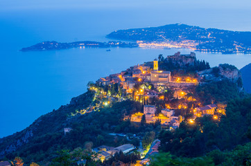 Eze village and the saint jean cap ferrat peninsula a dusk, blue hour, from the grand corniche