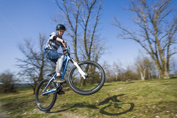 Fototapeta na wymiar boy jumping with his dirt bike