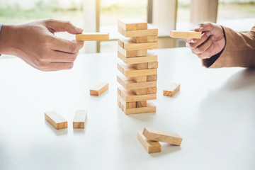 Alternative risk plan and strategy in business, Young intelligent business team playing the wood...