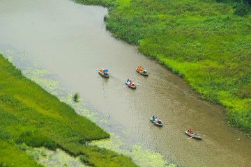 Yellow rice field on Ngo Dong river in Tam Coc Bich Dong from mountain top view in Ninh Binh...
