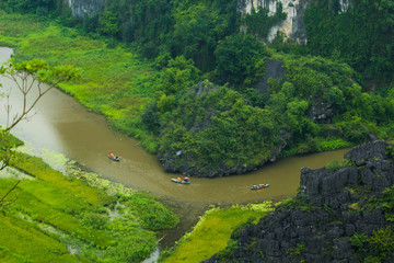 Yellow rice field on Ngo Dong river in Tam Coc Bich Dong from mountain top view in Ninh Binh province of Viet Nam