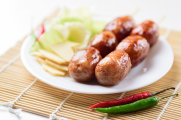 Thai sausage (Isan sausage) with chili and vegetables, popular Northeastern food in Thailand