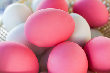 Close-up pink and white eggs in basket