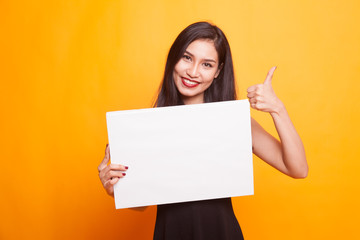 Fototapeta premium Young Asian woman show thumbs down with white blank sign.