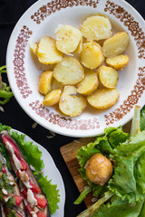 Baked , steamed new potato halves with spices, rock salt and olive or sunflower seeds oil. Raw vegan vegetarian healthy food for lunch or dinner. Organic farm product