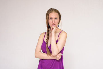 Portrait of a beautiful woman on a white background showing mistrust