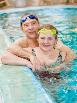 happy elderly couple in the pool