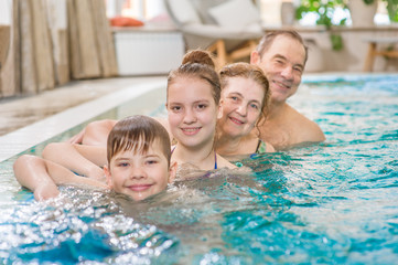 big family having fun in the pool