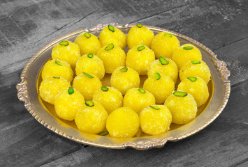 Indian Traditional Yellow Sweet Food Coconut Laddoo Also Know As Coconut Laddu, Ladoo, laddo Are Ball-Shaped Sweets on Wooden Background