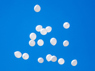 White balls flying in the blue sky