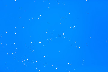 White balls flying in the blue sky