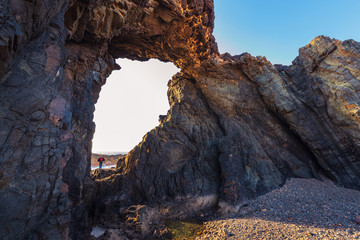 Woman observing the sea in the Jurado Arch, Fuerteventura, Spain