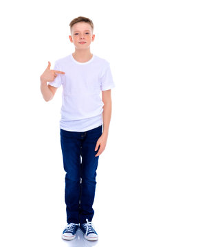 A school boy points to his white T-shirt.