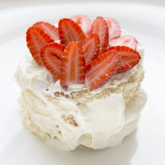 Close up strawberry cake dessert on a white plate.