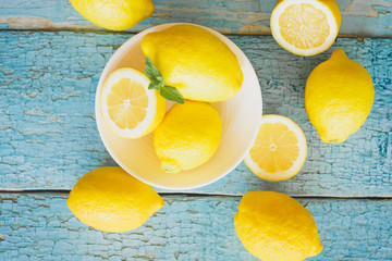 Yellow lemons with mint leaves