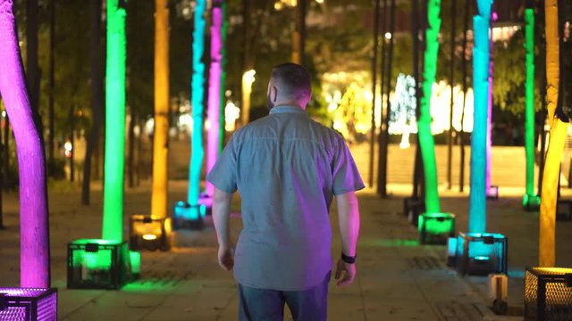 Young man admire skyscrapers in the city at night
