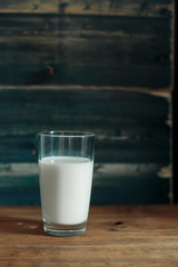 Milk in a glass on a table, breakfast in the morning