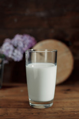Milk in a glass on a table, breakfast in the morning