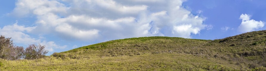 Fototapeta na wymiar Panorama view of green mountain with blue sky and white cloud