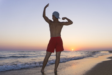 athlete posing on sunset background