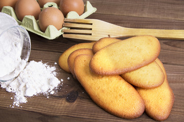 biscuits flour and eggs on wood