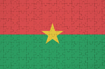 Burkina Faso flag  is depicted on a folded puzzle