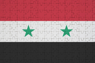 Syria flag  is depicted on a folded puzzle