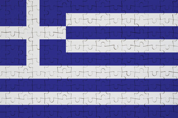 Greece flag  is depicted on a folded puzzle