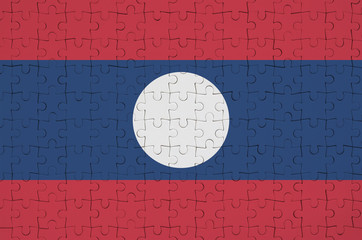 Laos flag  is depicted on a folded puzzle