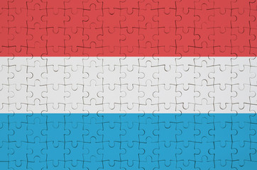 Luxembourg flag  is depicted on a folded puzzle