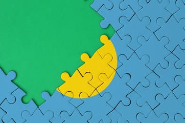 Palau flag  is depicted on a completed jigsaw puzzle with free green copy space on the left side