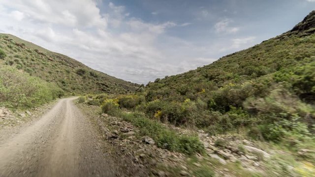 POV shot of the cami de ronda de Roses coastline in catalunya, spain shot from the front of an off road vehicle